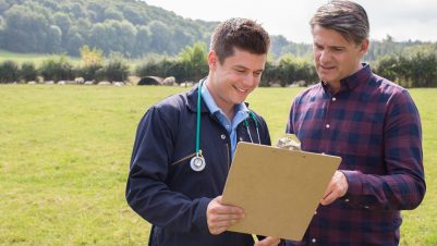 farmer and vet looking at clipboard